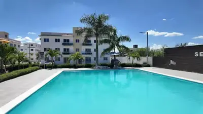a large swimming pool in front of a building at Residencial selene V, Family Modern Apartment w Pool & Near the beach in Punta Cana