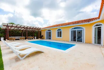 a villa with a swimming pool and a house at Sosua Ocean Village Properties by Calisto Stays in Sosúa