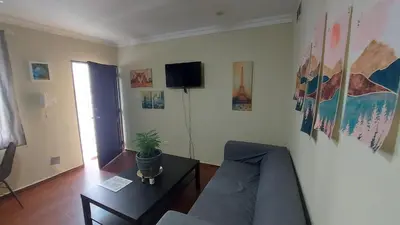a living room with a couch and a table at Casa Kamanda, Zona Colonial, Santo Domingo in Santo Domingo