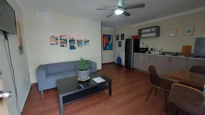 a living room with a blue couch and a table at Casa Kamanda, Zona Colonial, Santo Domingo in Santo Domingo