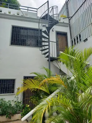 a white building with a spiral staircase on it at Casa Kamanda, Zona Colonial, Santo Domingo in Santo Domingo