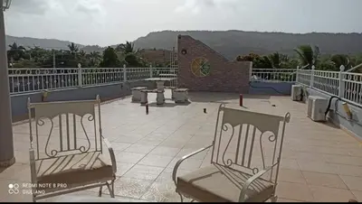 two chairs sitting on top of a roof at Apartamentos ipap luperon in Puerto de Luperon