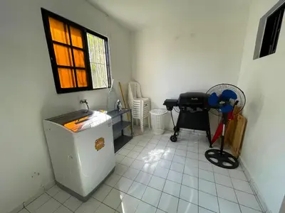 a bathroom with a sink and a table and a window at Casa Corona Plaza in Santiago de los Caballeros
