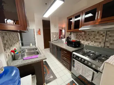 a kitchen with a sink and a stove top oven at Casa Corona Plaza in Santiago de los Caballeros