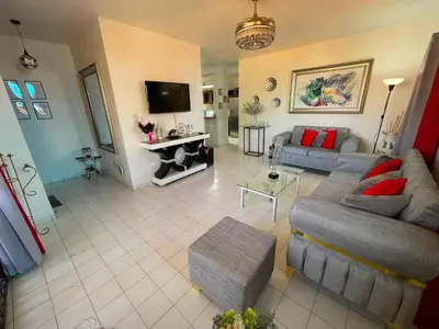 a living room with two couches and a tv at Casa Corona Plaza in Santiago de los Caballeros