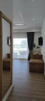 a mirror in a room with a large window at Hotel El Quemaito - Luxury Oceanfront Retreat in Santa Cruz de Barahona