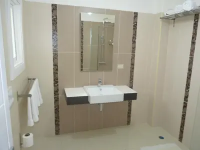 a bathroom with a sink and a mirror at Hotel El Quemaito - Luxury Oceanfront Retreat in Santa Cruz de Barahona