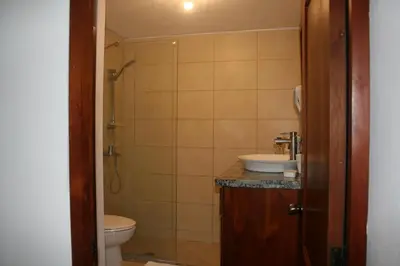 a bathroom with a sink and a toilet and a shower at Costambar Tropical Garden in San Felipe de Puerto Plata