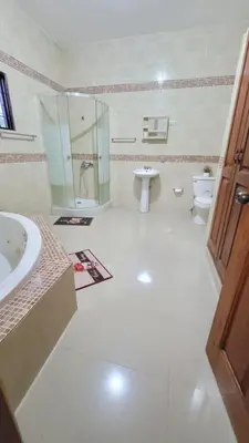a bathroom with a sink and a toilet and a shower at Jarabacoa Mountain Views in Jarabacoa