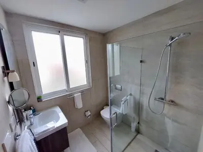 a bathroom with a shower and a sink and a toilet at Spectacular Apto Pool Golf View in Hard Rock Golf in Punta Cana