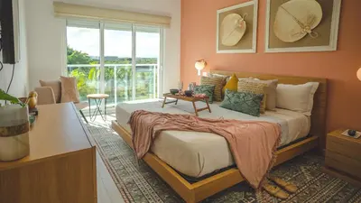 a bedroom with a large bed and a window at Hard Rock Area PH • Private Jacuzzi + Beach Views in Punta Cana