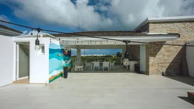 a white pergola with a table and chairs on a patio at Hard Rock Area PH • Private Jacuzzi + Beach Views in Punta Cana