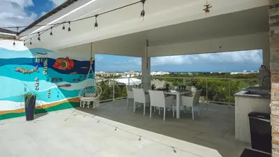 a patio with a table and chairs on a balcony at Hard Rock Area PH • Private Jacuzzi + Beach Views in Punta Cana