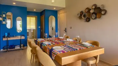 a dining room with a wooden table and chairs at Luxury Condo with Golf Cart Included in Cana Pearl in Punta Cana