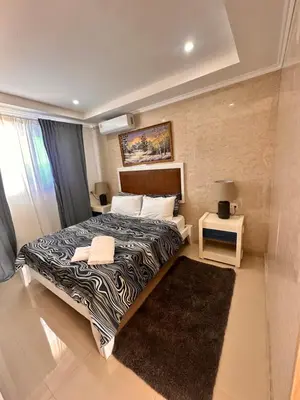 a hotel room with a bed and a night stand at Noè Hotel 1 Bedroom #6 in Punta Cana