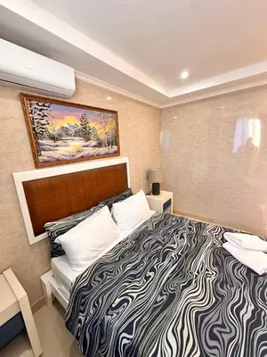 a bedroom with a large bed with a black and white comforter at Noè Hotel 1 Bedroom #6 in Punta Cana
