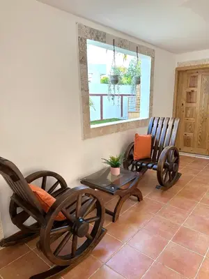 two rocking chairs and a table in a room at Noè Hotel 1 king bedroon #7 in Punta Cana