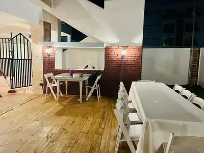 a dining room with a table and white chairs at Noè Hotel 1 king bedroom # 10 in Punta Cana