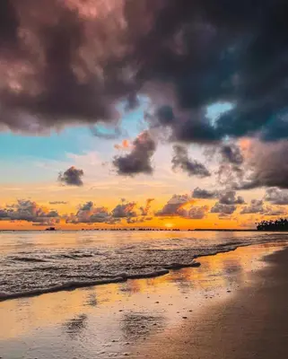 a beach with a cloudy sky and the ocean at Noè Hotel 1 king bedroom # 10 in Punta Cana