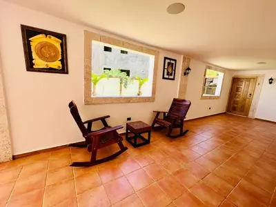 a living room with two chairs and a table at Noè Hotel 1 king bedroom # 10 in Punta Cana