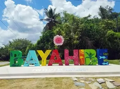 a sign for a park with a palm tree in the background at My Dominicus Beach Retreat in Bayahibe