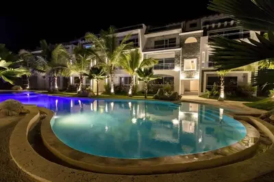 a swimming pool in front of a building at night at My Dominicus Beach Retreat in Bayahibe