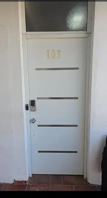 a white garage door with the number on it at 4 Bedroom 4 Bath & Laundry Room Apartment in Sosúa