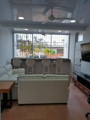 a living room with a couch and chairs and windows at 4 Bedroom 4 Bath & Laundry Room Apartment in Sosúa