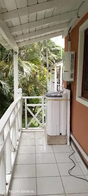 a porch of a house with a microwave at Paradise Apartment with senic pool in beach area in El Callejón