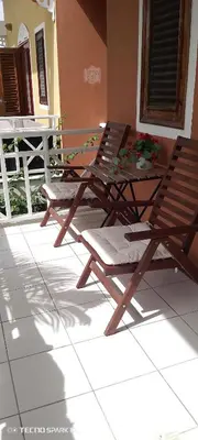 two folding chairs and a table on a patio at Paradise Apartment with senic pool in beach area in El Callejón