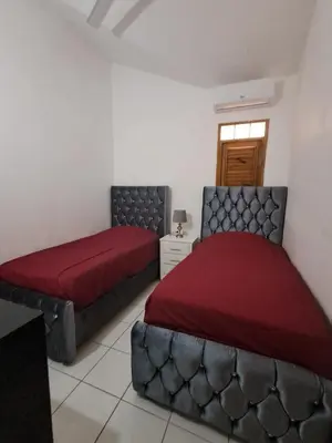 a bedroom with two beds with red covers and a window at Paradise Apartment with senic pool in beach area in El Callejón