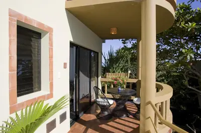 a patio with a table and chairs on a balcony at El Magnifico in Cabarete