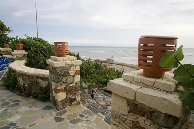 a stone wall with a view of the ocean at El Magnifico in Cabarete