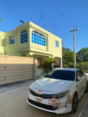 a white car parked in front of a house at Luxury Apartment By Merengue House in Boca Chica