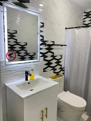 a bathroom with a sink and a toilet and a mirror at Luxury Apartment By Merengue House in Boca Chica