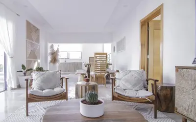 a living room with two chairs and a table at New Beachfront Penthouse in Las Terrenas