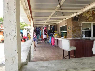 a bar at a market with people walking around at CortLang Vacation Rentals, El Pueblito in San Felipe de Puerto Plata