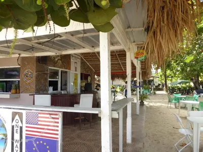 an outdoor restaurant with an american flag on a table at CortLang Vacation Rentals, El Pueblito in San Felipe de Puerto Plata