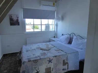 a bedroom with a bed and a window at CortLang Vacation Rentals, El Pueblito in San Felipe de Puerto Plata
