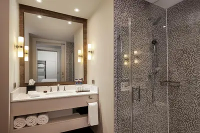 a bathroom with a sink and a shower at Embassy Suites by Hilton Santo Domingo in Santo Domingo