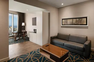 a living room with a couch and a table at Embassy Suites by Hilton Santo Domingo in Santo Domingo