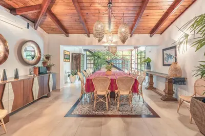 a dining room with a table and chairs at Fun in the sun classic villa at Los Lagos in Casa de Campo in Cajuiles