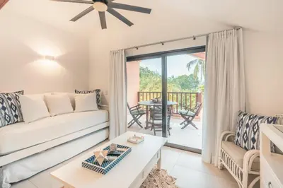 a living room with a couch and a table at Fun in the sun classic villa at Los Lagos in Casa de Campo in Cajuiles