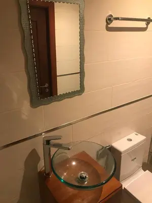 a bathroom with a glass sink and a mirror at Hotel Blue Malecón And Spa in Santo Domingo