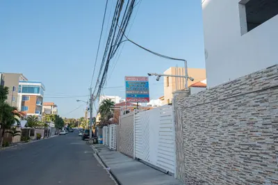 an empty street with a brick wall next to a building at Cozy Double Room in Santo Domingo Este in La Viva