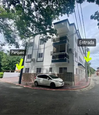 a white car parked in front of a building at Acogedor apartamento 2 hab Distrito nacional, próximo agora mall in Santo Domingo
