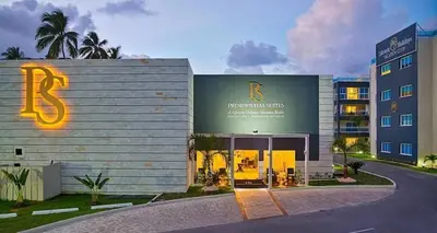 a building with a sign on the side of it at Chic Beachfront Apartment - Private Beach Access in Punta Cana