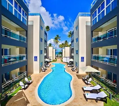 a swimming pool in the middle of a building at Chic Beachfront Apartment - Private Beach Access in Punta Cana