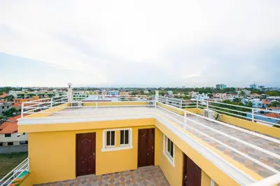 a view from the roof of a yellow building at Comfort Studio Kitchen- Corales del SurOle Las Americas- Isabelita - Aeropuerto in La Viva