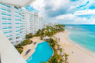 a view of the beach from the balcony of a resort at 3 Bedrooms At Marbella Beachfront Juan Dolio in Juan Dolio